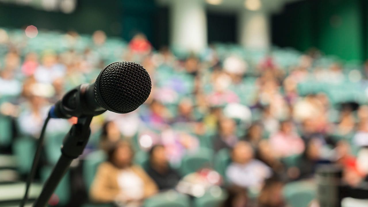 Microphone in the centre with people in the background