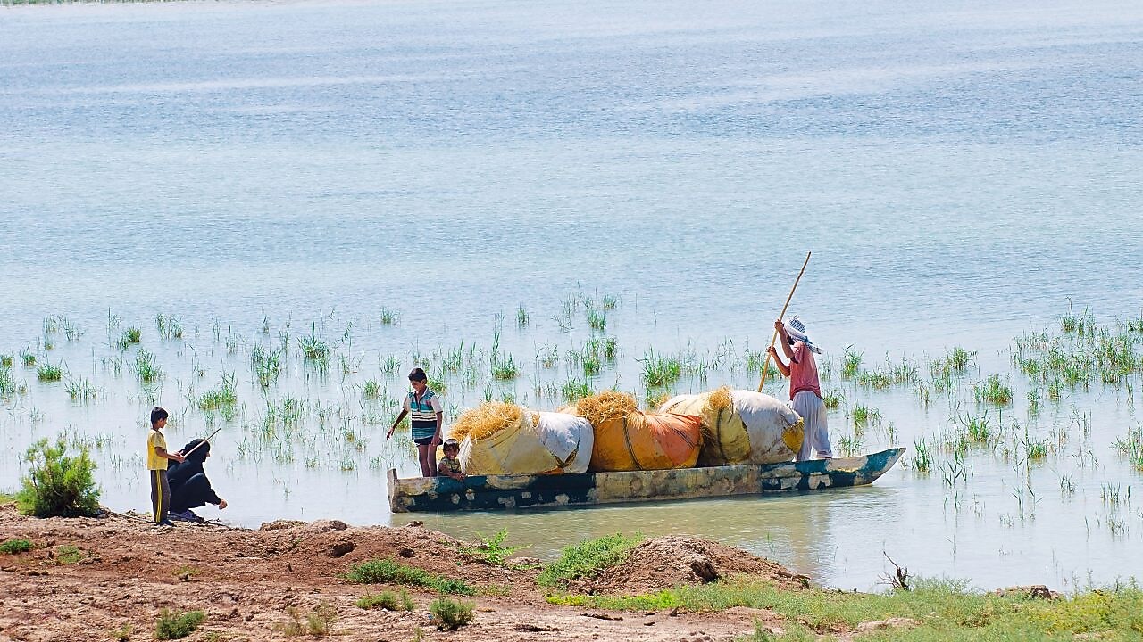 Local people on the Yabani Canal in the South of Iraq