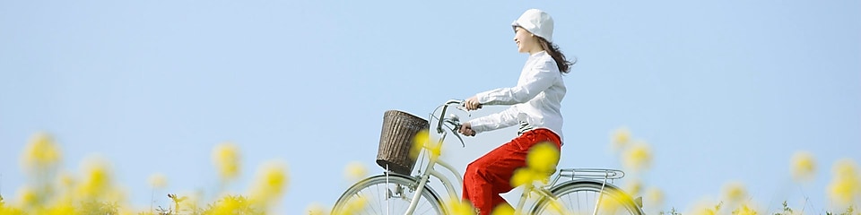 Një vajzë duke pedaluar biçikletën në fushë