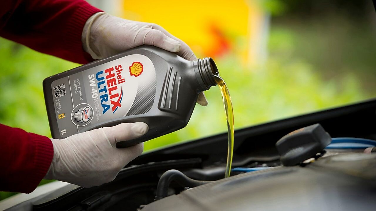 shell helix ultra being poured into engine