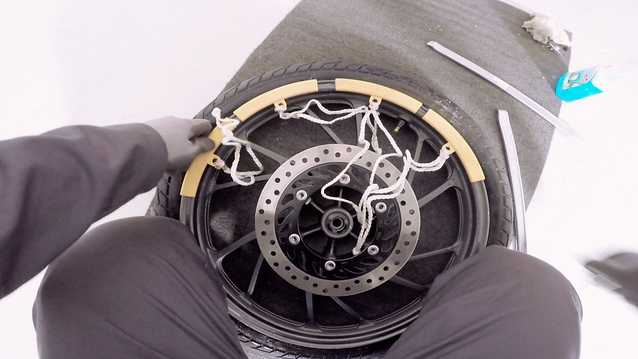 hands getting a tyre off the rim