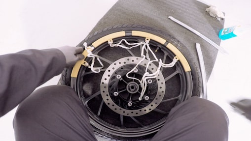 hands getting a tyre off the rim